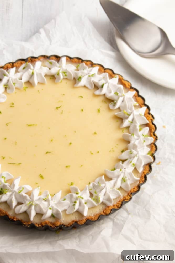 Effortless Vegan Key Lime Bliss 5 Close-up of fluffy coconut whipped cream with a background of a vegan key lime pie.