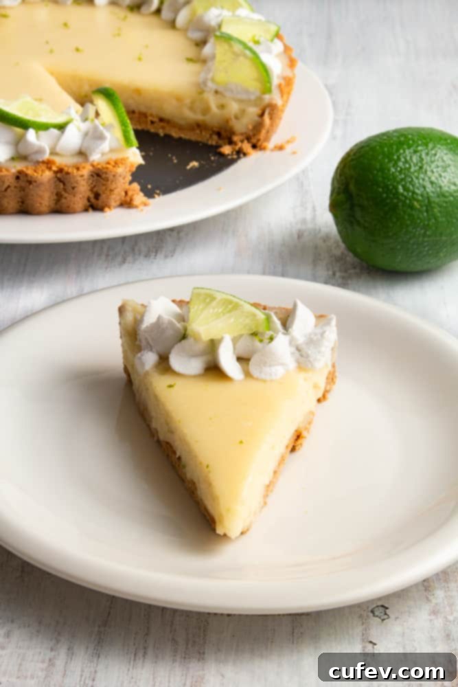 Effortless Vegan Key Lime Bliss 7 Four slices of vibrant vegan key lime pie on a wooden board, garnished with whipped cream and lime zest.
