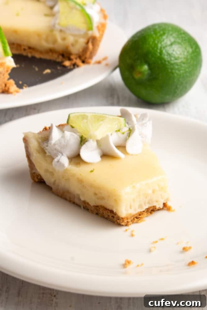 Effortless Vegan Key Lime Bliss 8 Close-up of a single slice of vegan key lime pie on a plate, showcasing its creamy texture, crust, and whipped topping.