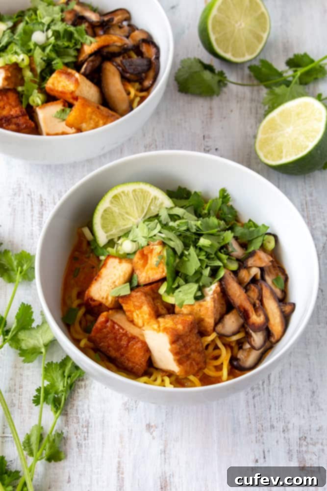 Overhead shot of a delicious and creamy vegan Thai red curry ramen bowl, ready to be enjoyed.