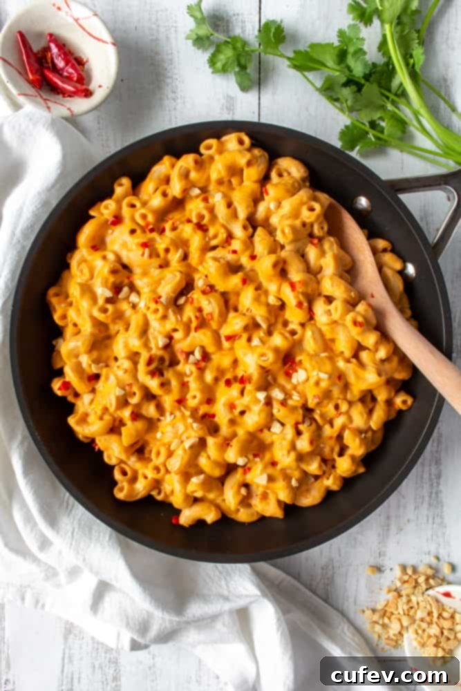 This vegan red curry mac and cheese is comfort food with a kick! The addition of Thai red curry paste and lime juice gives this creamy vegan mac and cheese a spicy tang! #thaicurry #redcurry #vegan #macandcheese #macncheese #vegancheese