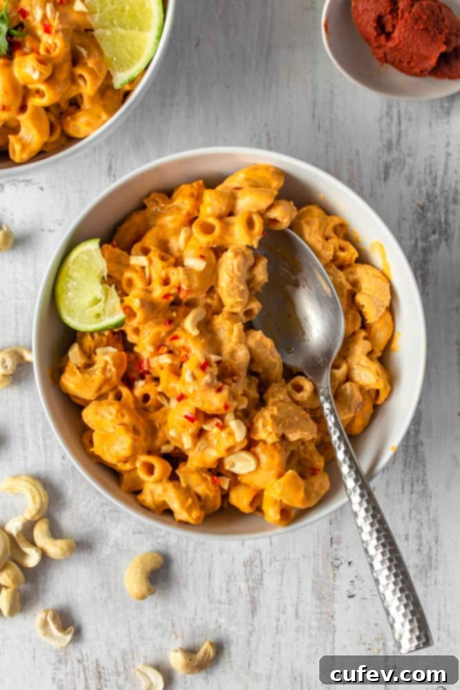 This vegan red curry mac and cheese is comfort food with a kick! The addition of Thai red curry paste and lime juice gives this creamy vegan mac and cheese a spicy tang! #thaicurry #redcurry #vegan #macandcheese #macncheese #vegancheese