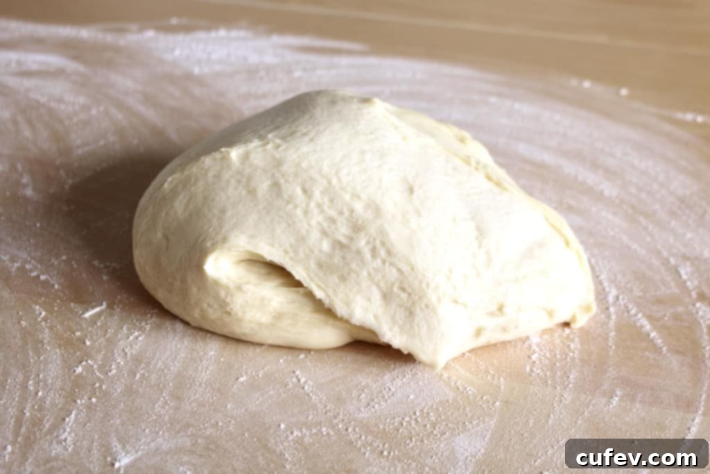 Perfectly risen doughnut dough, light and airy, ready for shaping on a lightly floured surface.