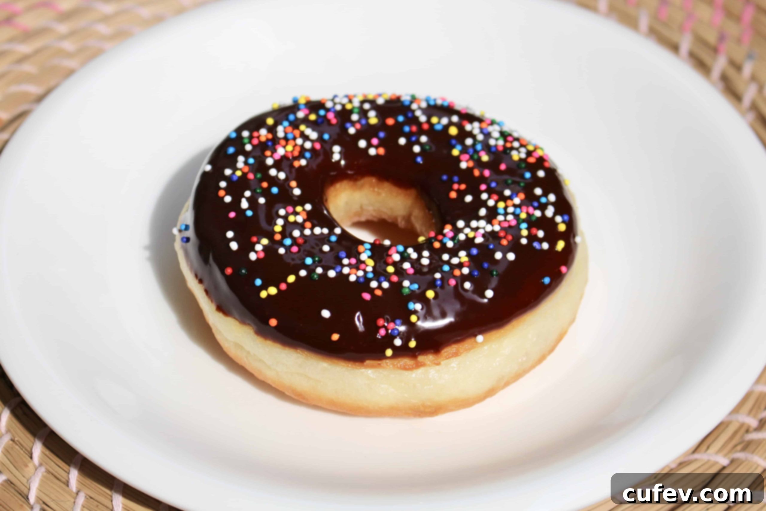A selection of fluffy homemade yeasted doughnuts, glazed and topped with sprinkles, highlighting their delicious appeal and perfect for sharing on social media.