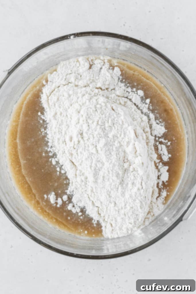 Wet ingredients and dry ingredients just mixed together in a bowl, forming a smooth batter.