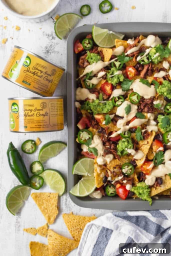 Shredded jackfruit cooking in a pan with spices, ready to be used as a delicious vegan meat alternative for nachos.