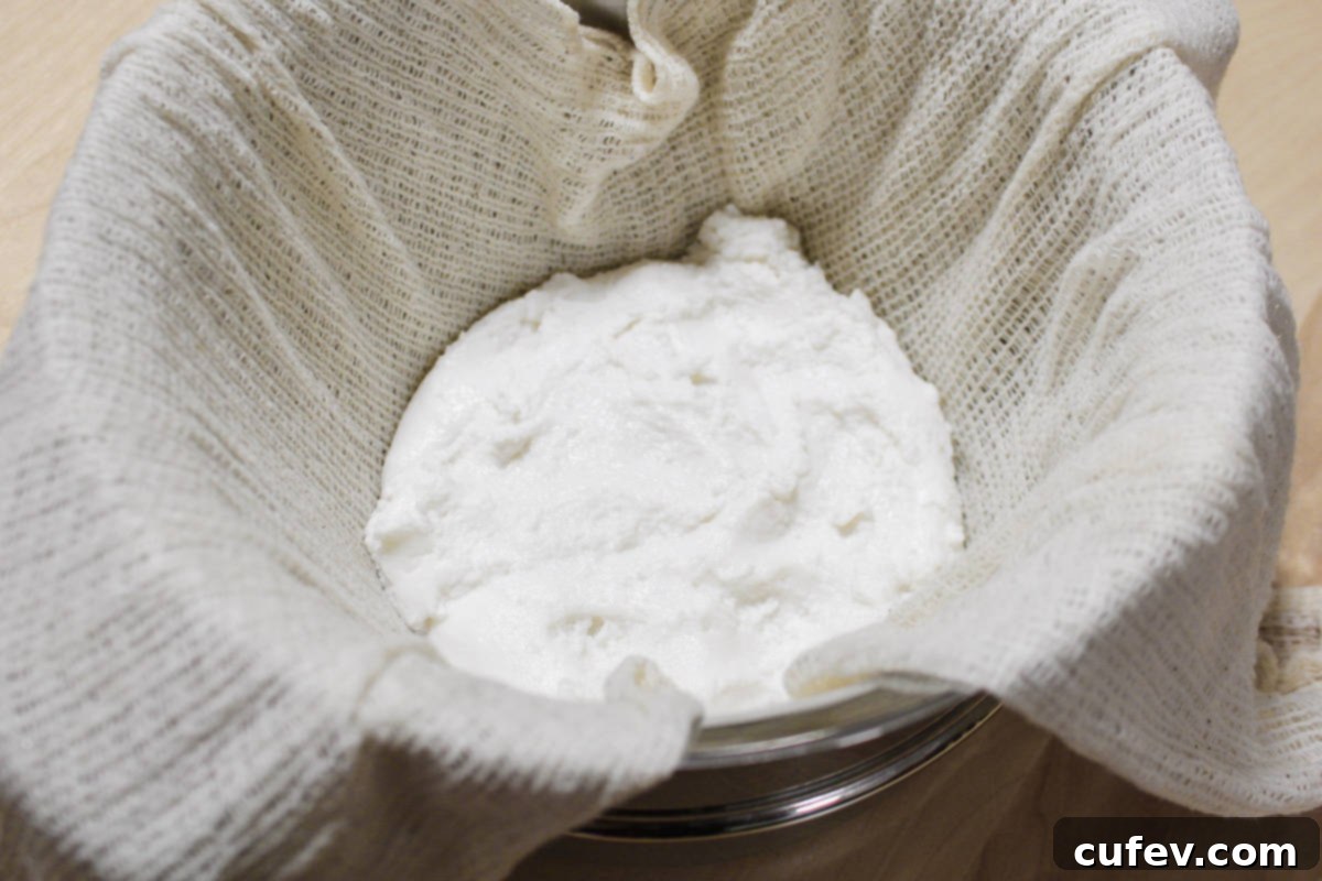 The mochi dough placed inside a cheesecloth-lined pan, ready for its initial steaming process to achieve a perfectly tender texture.
