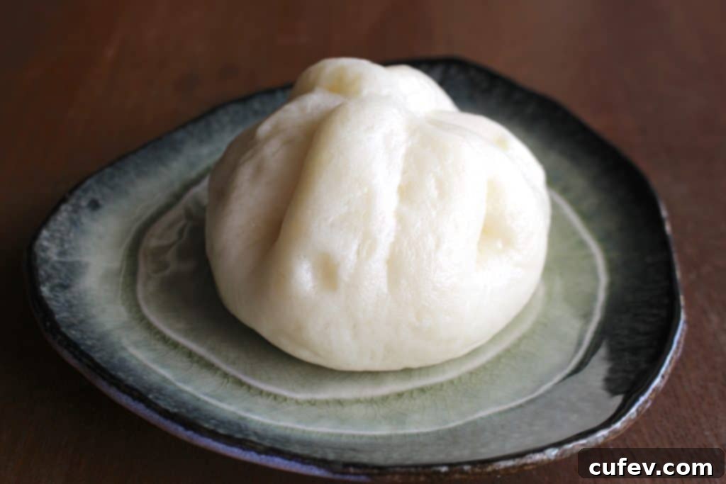 A batch of fluffy, freshly steamed pork buns, ready to be enjoyed.