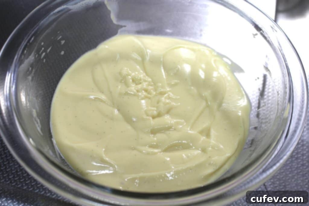Smooth, creamy, and pale yellow custard filling in a glass bowl, ready to be chilled