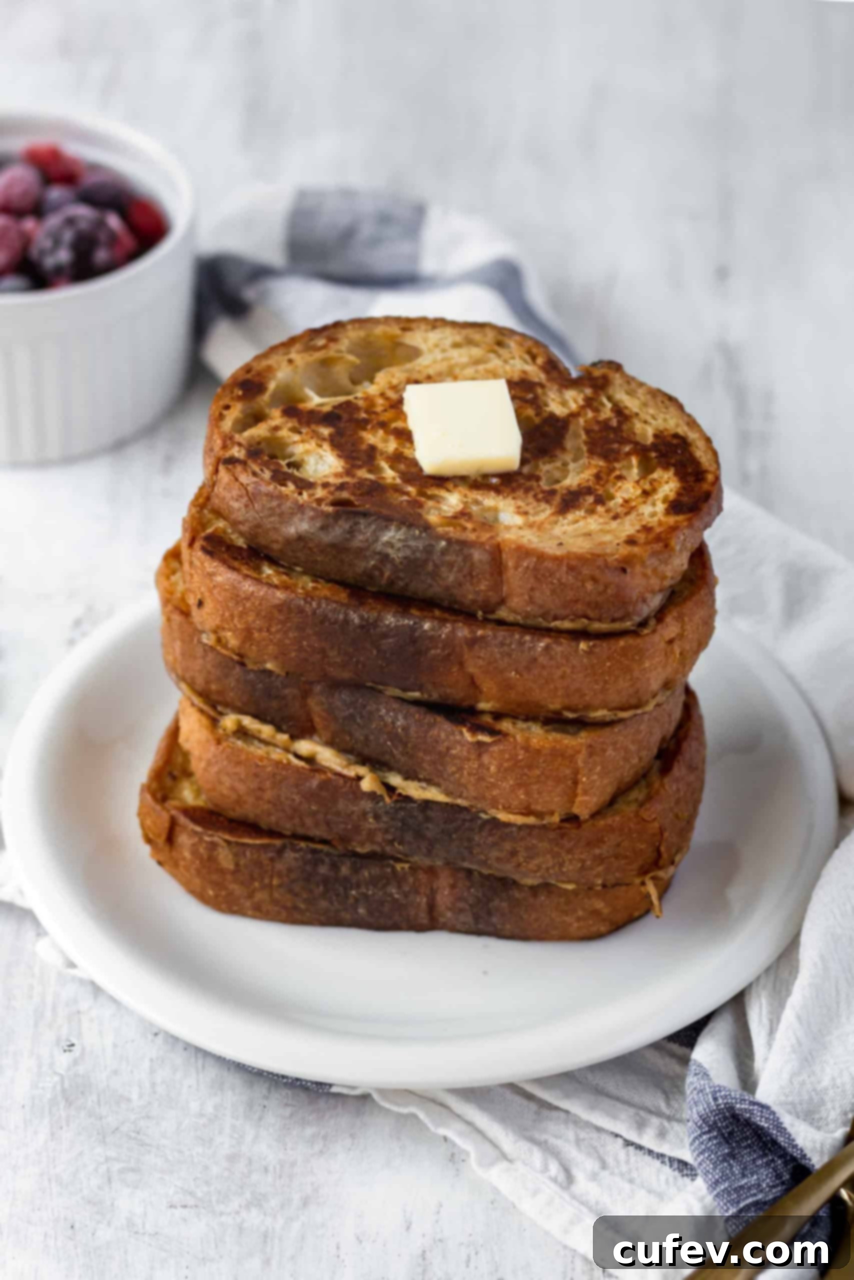 Close-up of golden-brown vegan French toast, showcasing its delightful texture and readiness for topping. #veganfrenchtoast #veganbreakfast #veganbrunch #plantbasedmeals #frenchtoast