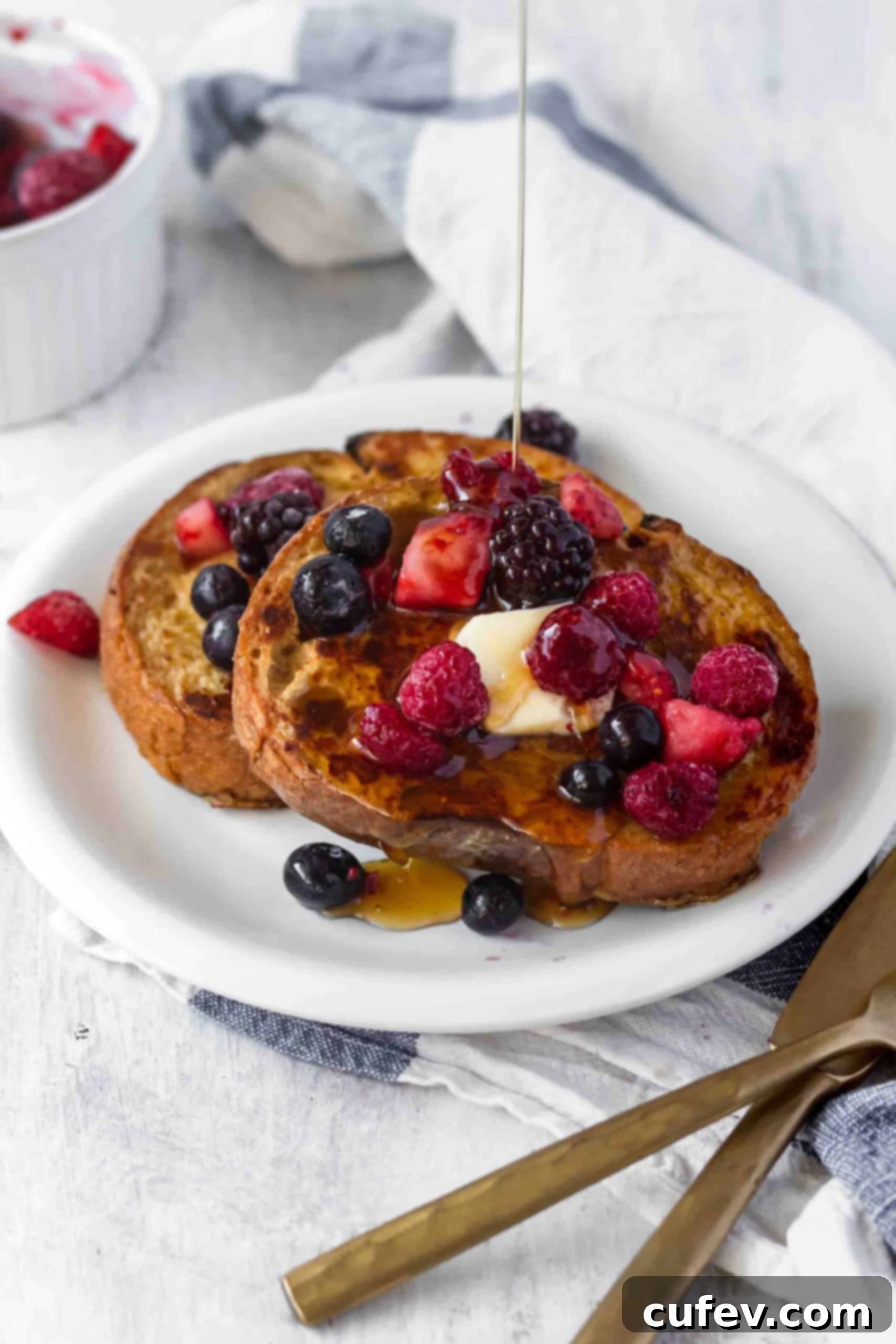 A stack of perfectly cooked vegan French toast, golden-brown and ready to be served. #veganfrenchtoast #veganbreakfast #veganbrunch #plantbasedmeals #frenchtoast