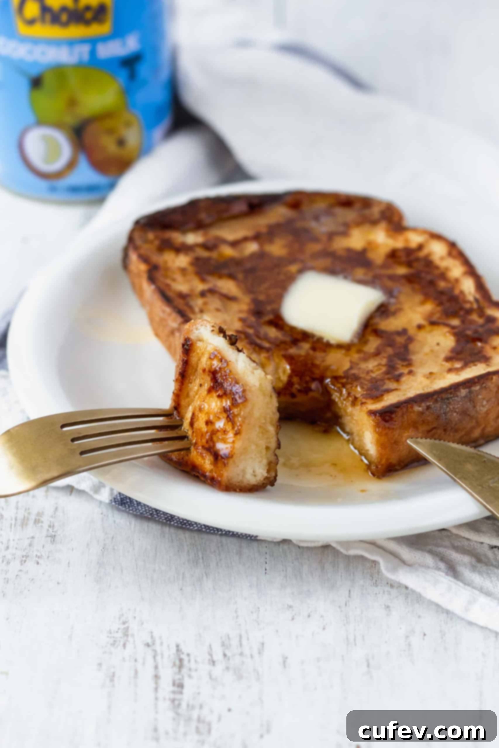 A beautifully topped stack of vegan French toast with mixed berries and powdered sugar. The perfect plant-based breakfast or brunch! Super easy and delicious! #veganfrenchtoast #veganbreakfast #veganbrunch #plantbasedmeals #frenchtoast
