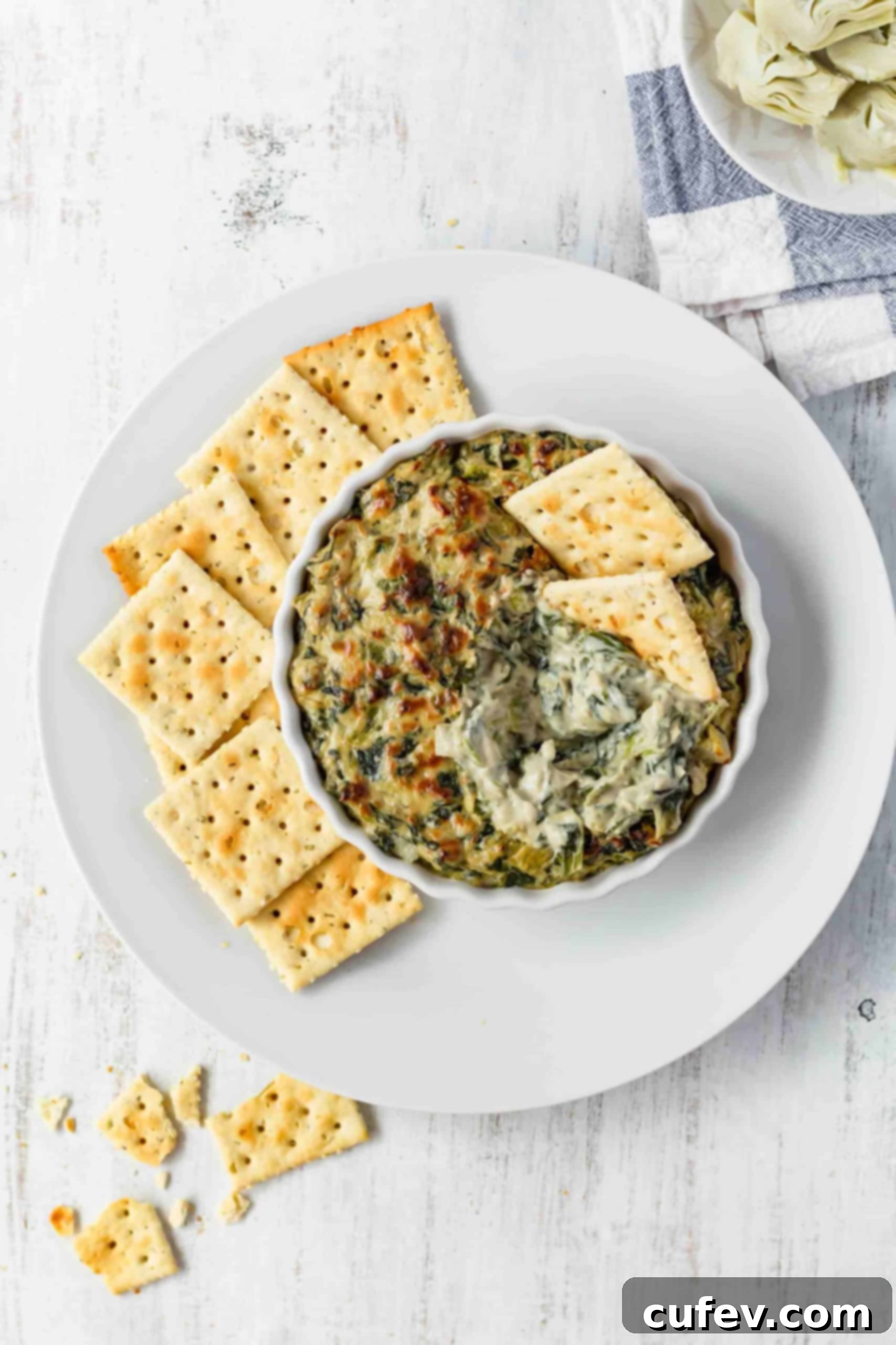 This vegan spinach and artichoke dip is dairy-free and gluten-free but full of creamy coconut milk, and cheesy cashews and nutritional yeast! #spinachdip #artichokedip #spinachandartichoke #dip #vegandip #veganappetizer #holidayappetizer