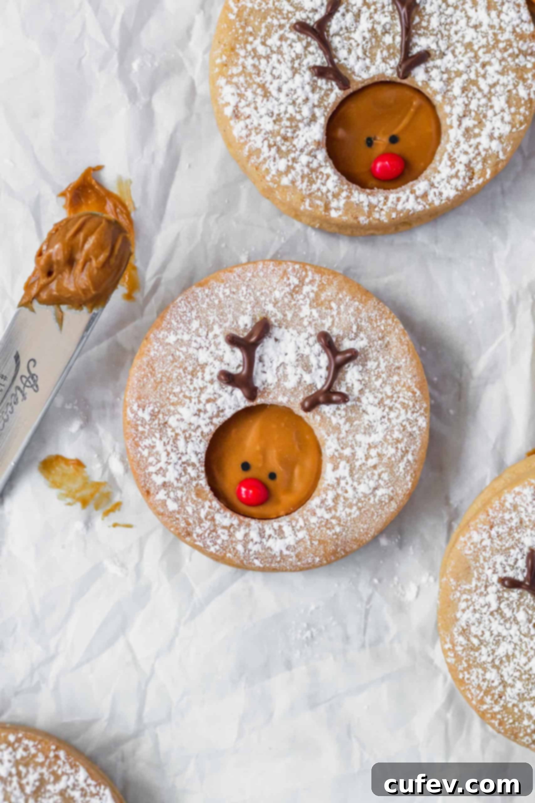 Rudolph reindeer cookies displayed on a white surface, showcasing their adorable design and festive appeal.