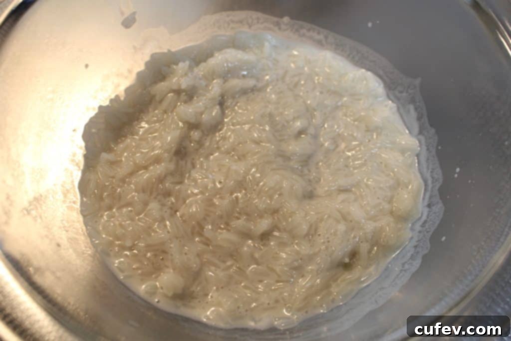 Coconut milk, sugar, and salt mixture heating in a saucepan for sticky rice