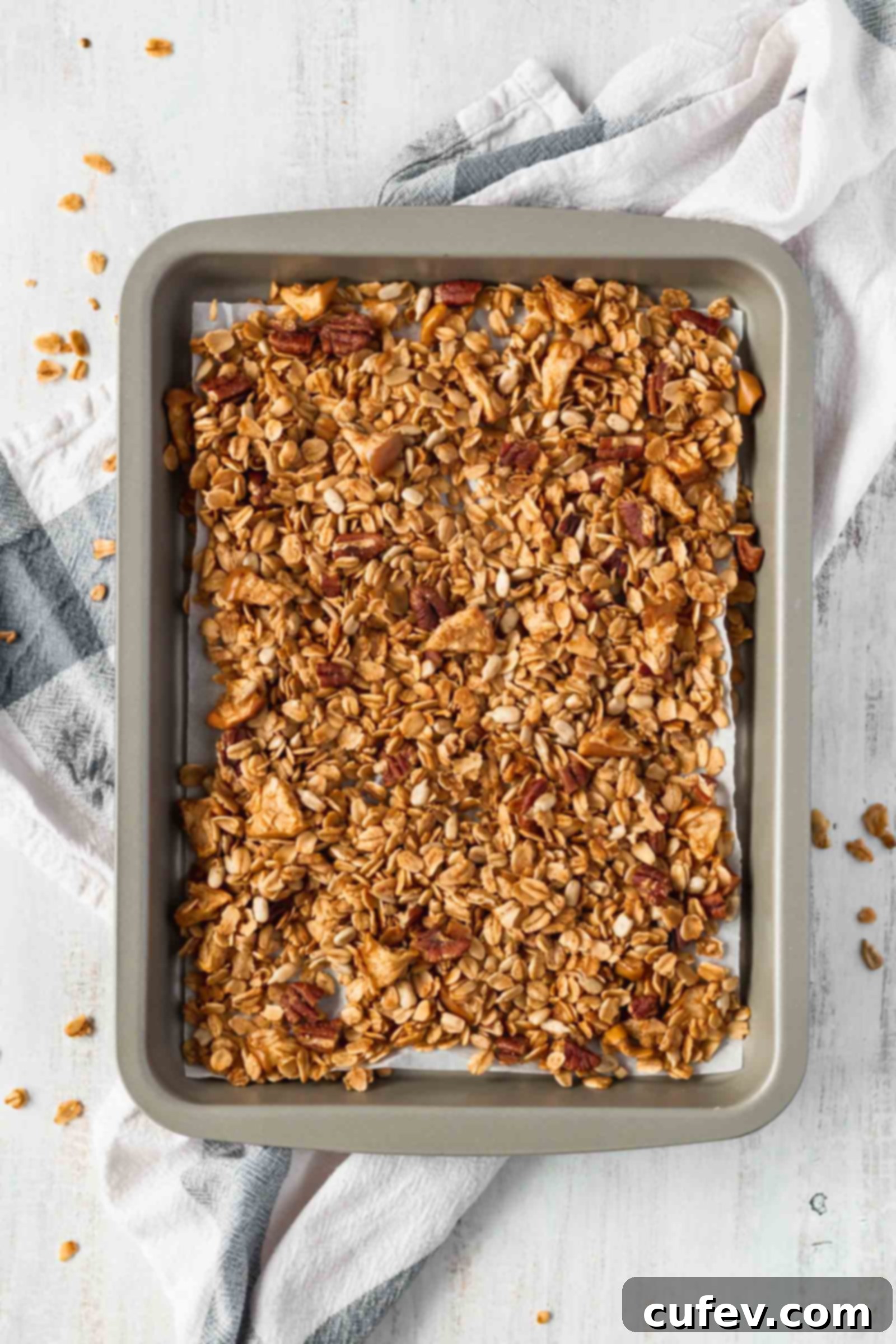 Crunchy homemade apple pie granola with fresh apple slices and warming spices, a healthy and delicious gluten-free breakfast idea.