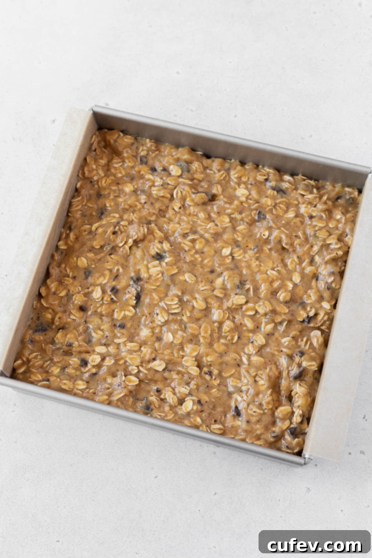 A pan of peanut butter banana oatmeal bars before going into the oven.