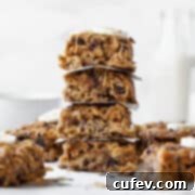 An up-close side shot of a stack of peanut butter banana oatmeal bars with other bars in the background.