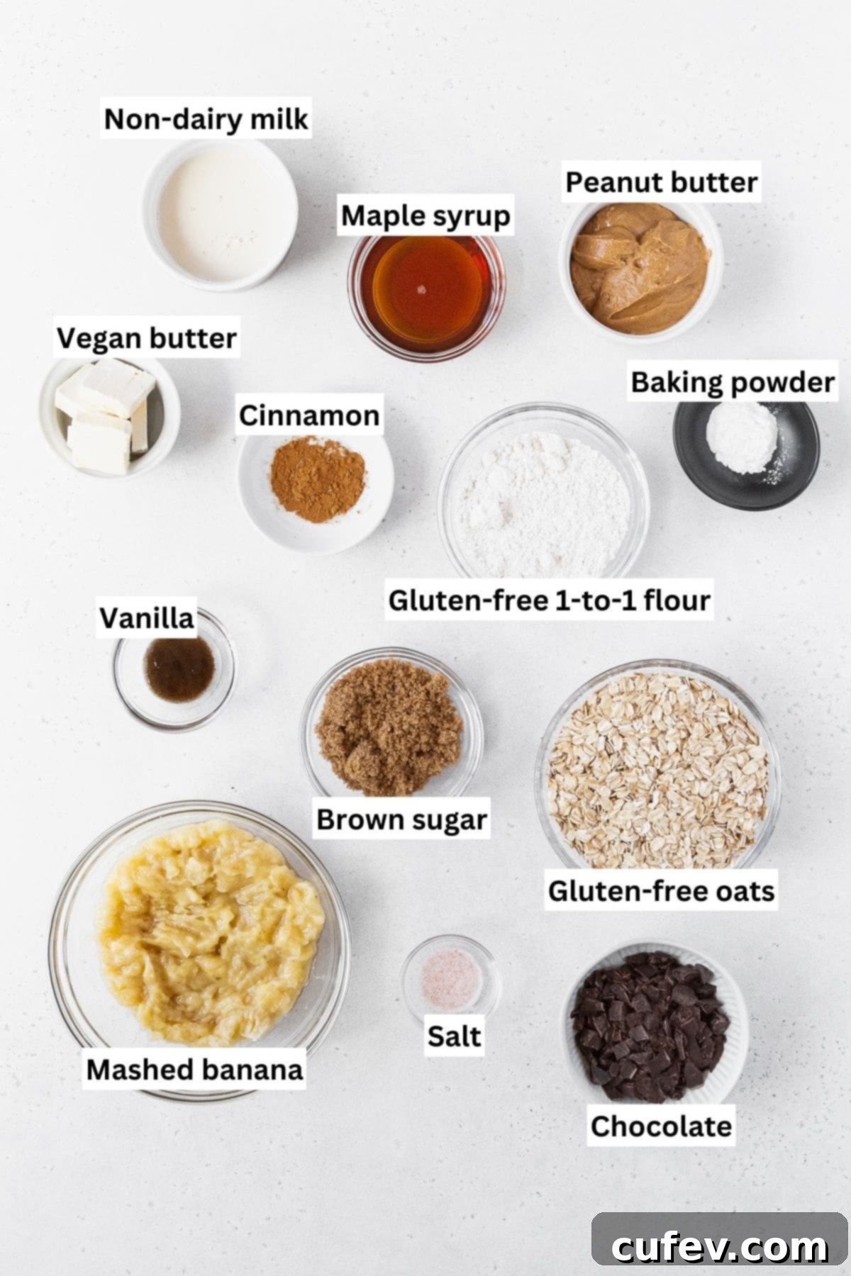 All of the ingredients for peanut butter banana oatmeal bars on a white background.