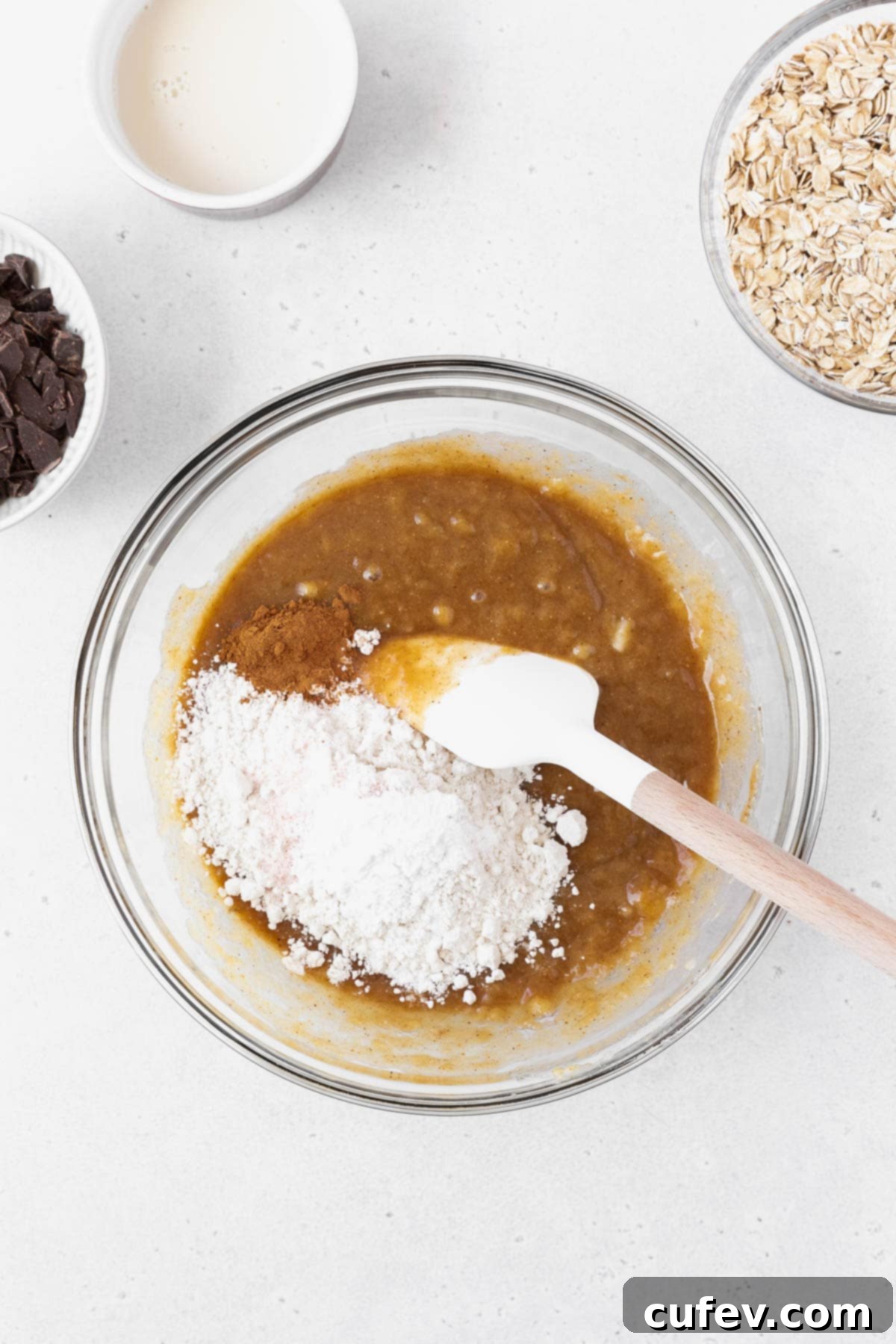 Stirring flour into the peanut butter and banana wet ingredients.