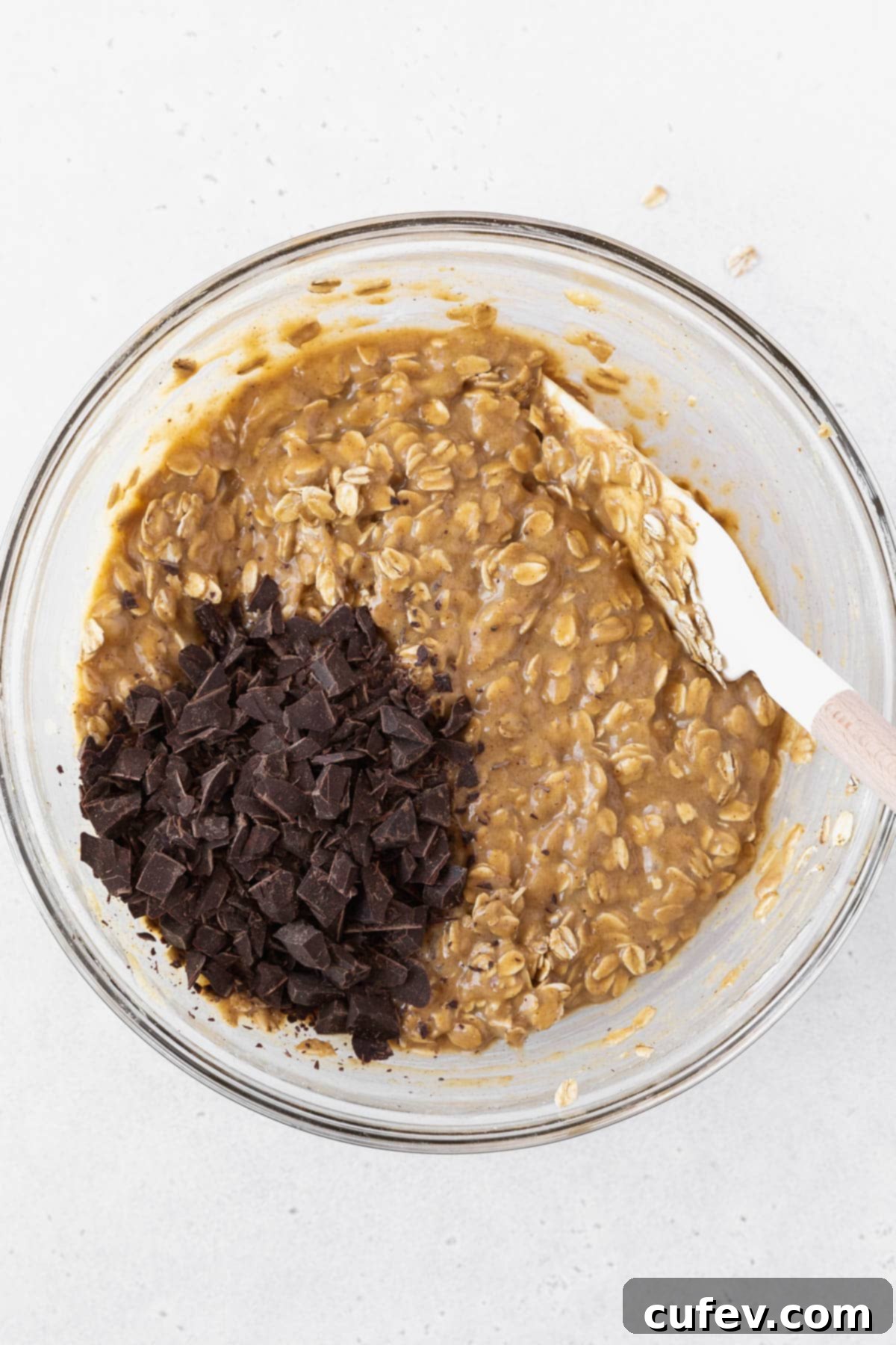 Stirring the shaved chocolate into the peanut butter banana oatmeal bar batter.