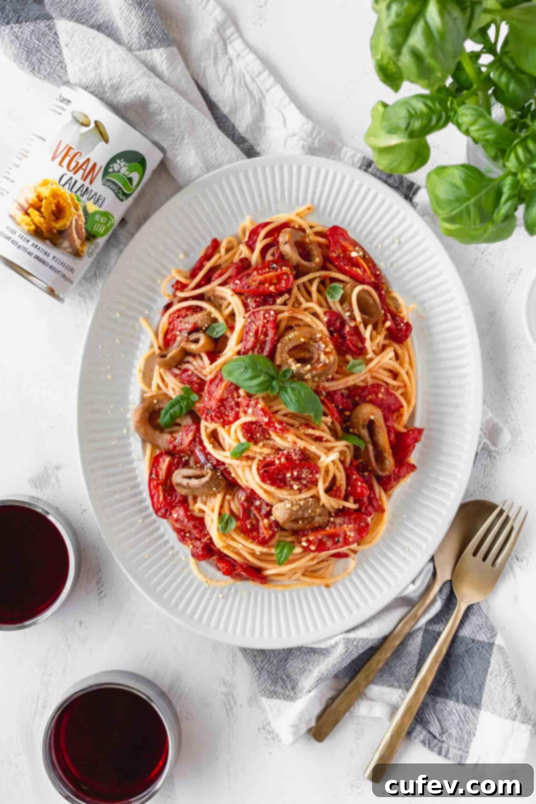 Vegan Calamari and Burst Tomato Pasta 4 A plate of vegan and gluten-free spaghetti with cherry tomato sauce and a can of vegan calamari