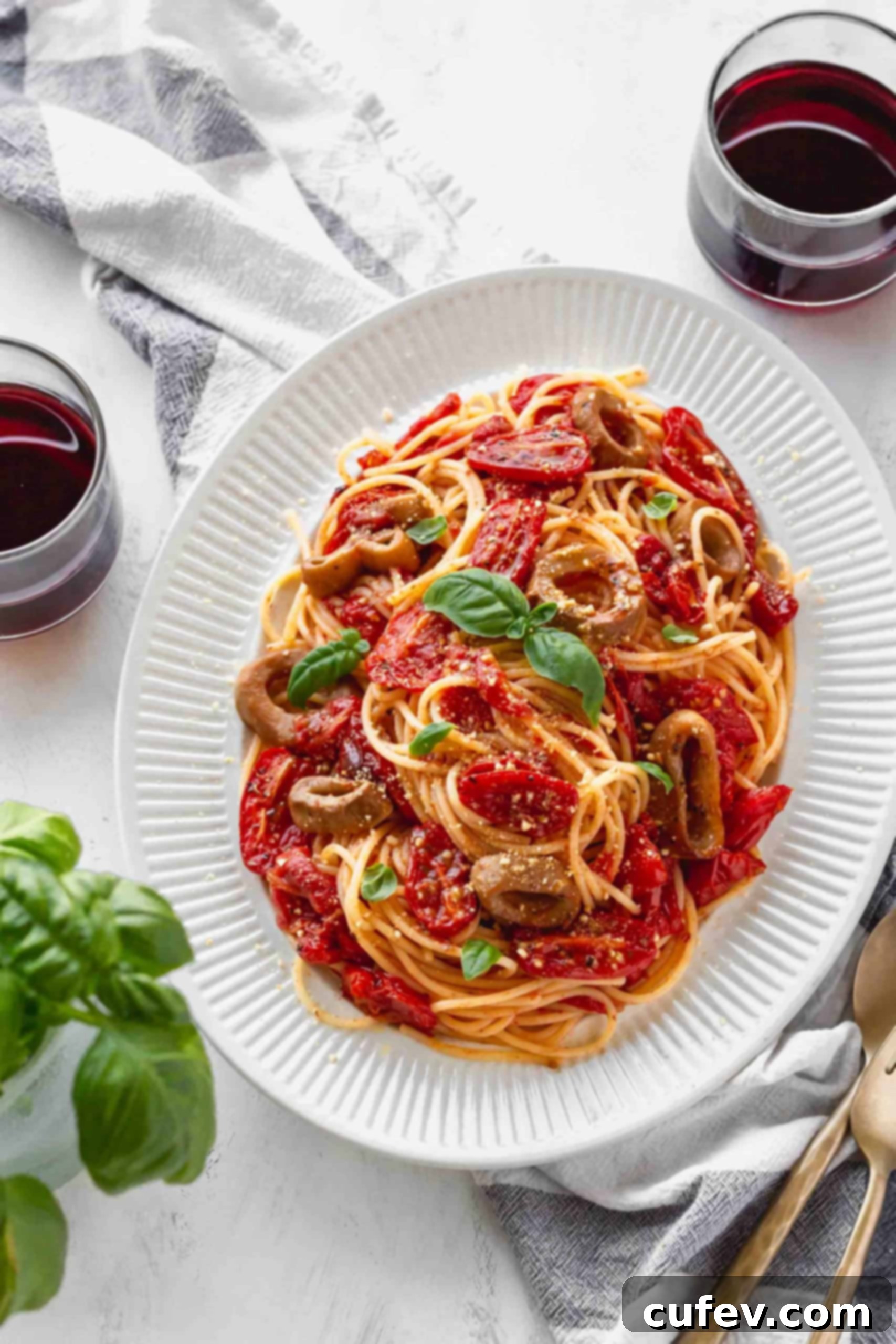 Vegan Calamari and Burst Tomato Pasta 6 Plate of spaghetti with roasted tomatoes and vegan calamari with two glasses of red wine