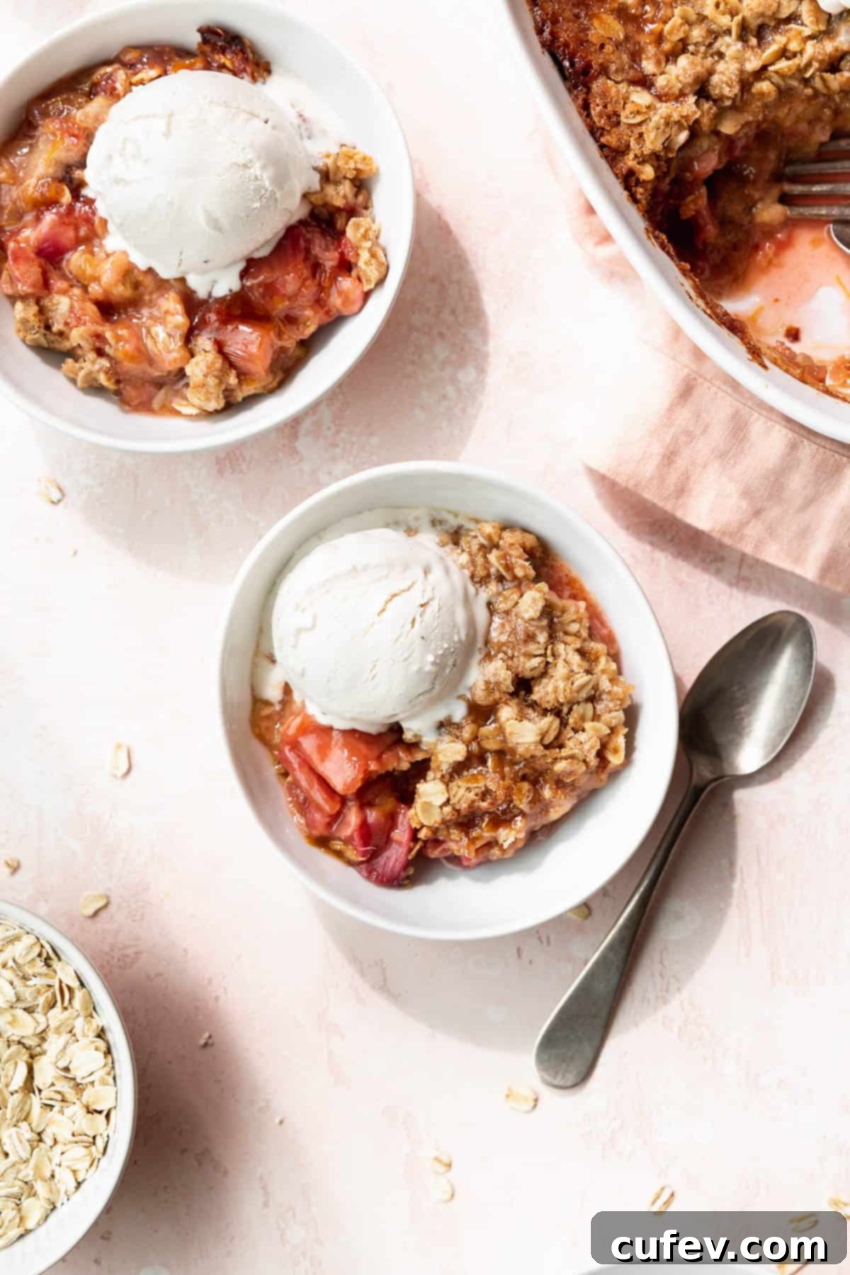 Rustic Rhubarb Crisp Gluten Free 3 Overhead shot of two bowls of vegan rhubarb crisp topped with vanilla ice cream.