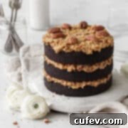 Gluten-free German chocolate cake on a round white board on a neutral linen.