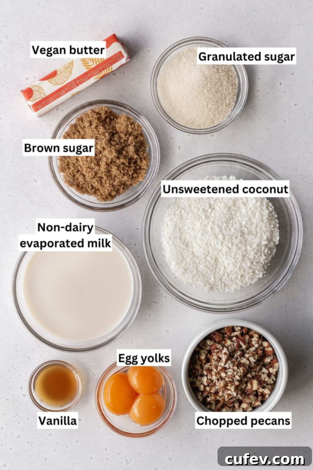 German chocolate frosting ingredients measured out into bowls and placed on a grey surface with text overlay.