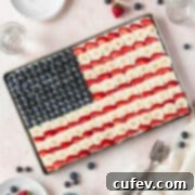 A square image of the entire sheet pan of gluten free and dairy free American flag dessert pizza with blueberries, bananas, and strawberries.
