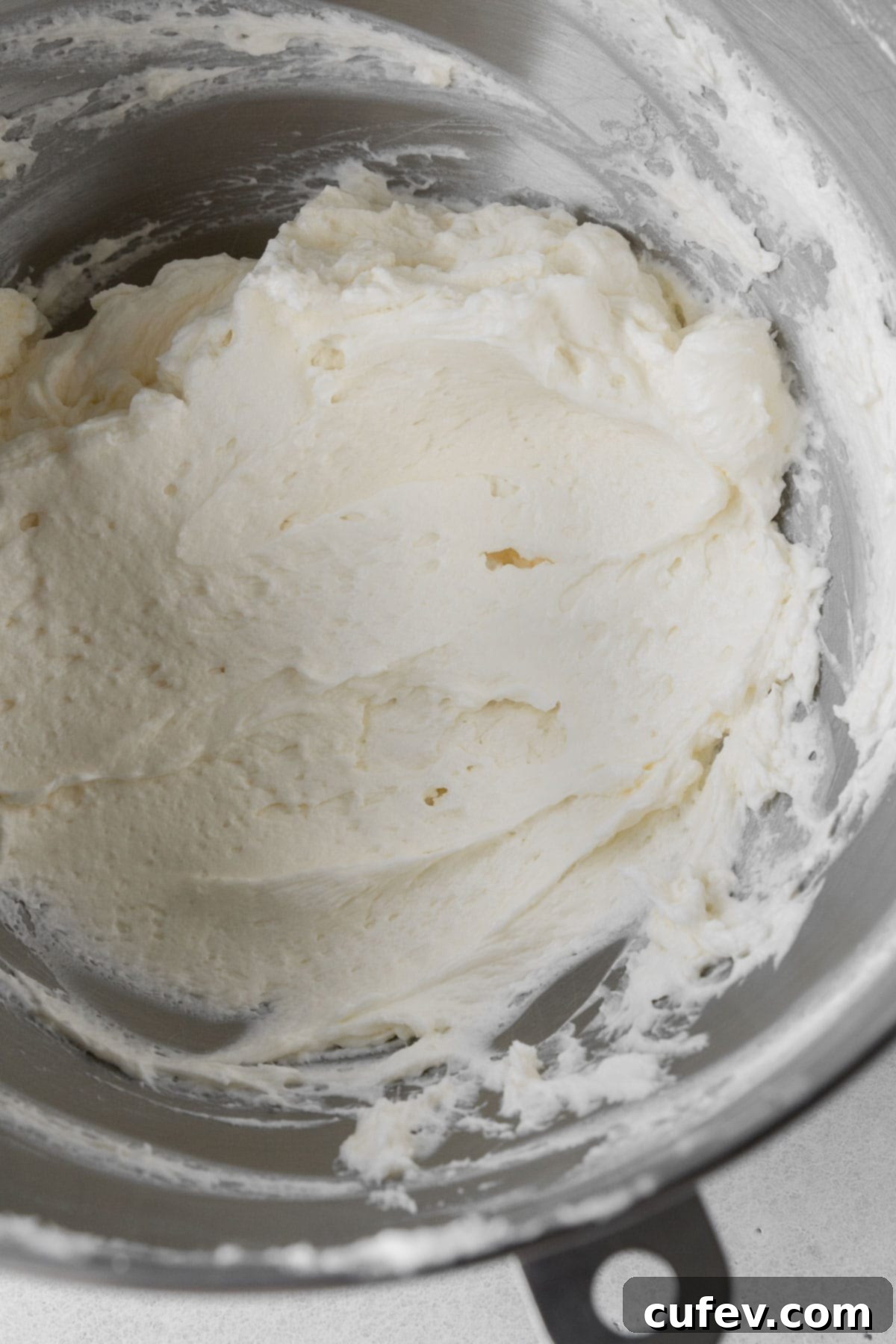 The rich and creamy vegan cream cheese frosting, perfectly smooth after adding all remaining ingredients, ready to be spread.