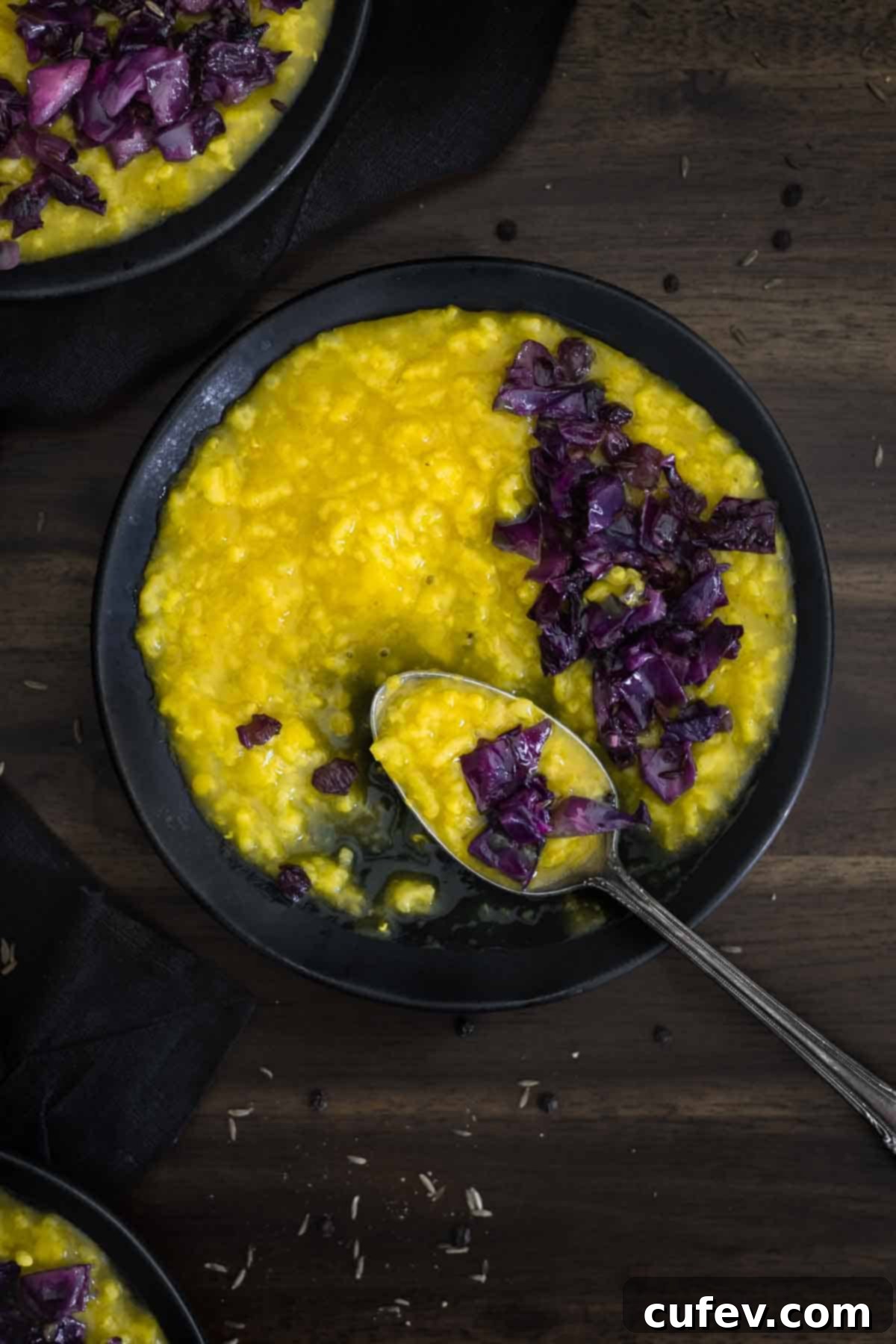 A delicious bowl of Khichdi, perfectly portioned with a spoon, ready to be enjoyed as a nourishing meal.
