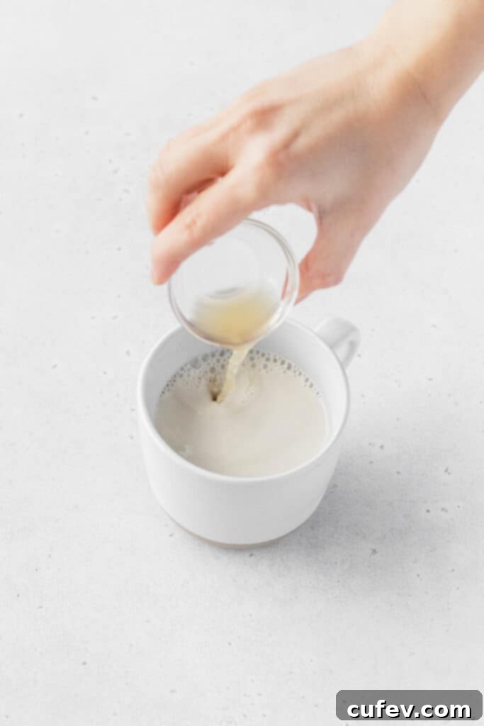 Golden Gluten-Free Cornbread Delight 5 Pouring apple cider vinegar into non-dairy milk to make vegan buttermilk.