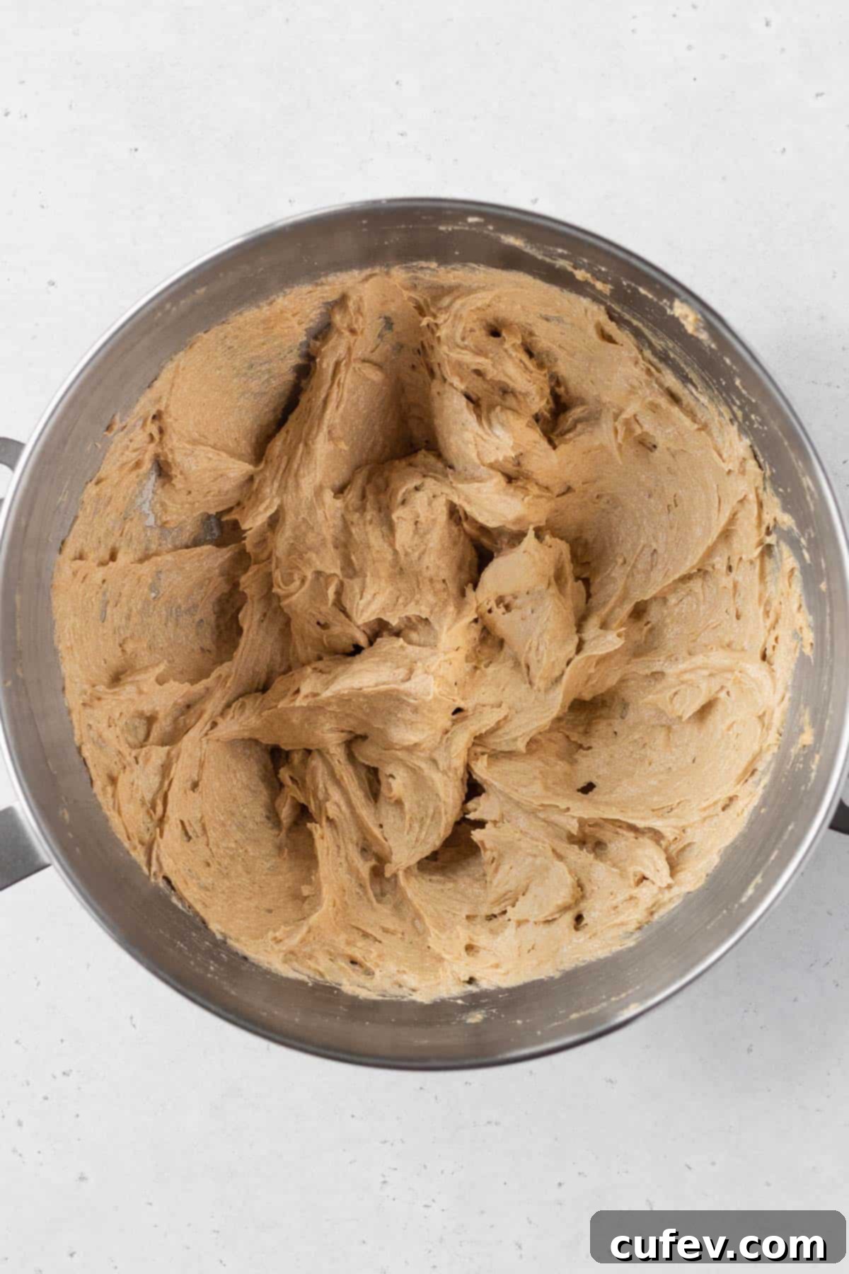 Wet ingredients for gluten-free dairy-free chocolate chip cookies, showing the mixture after adding egg and vanilla, appearing smooth and creamy.
