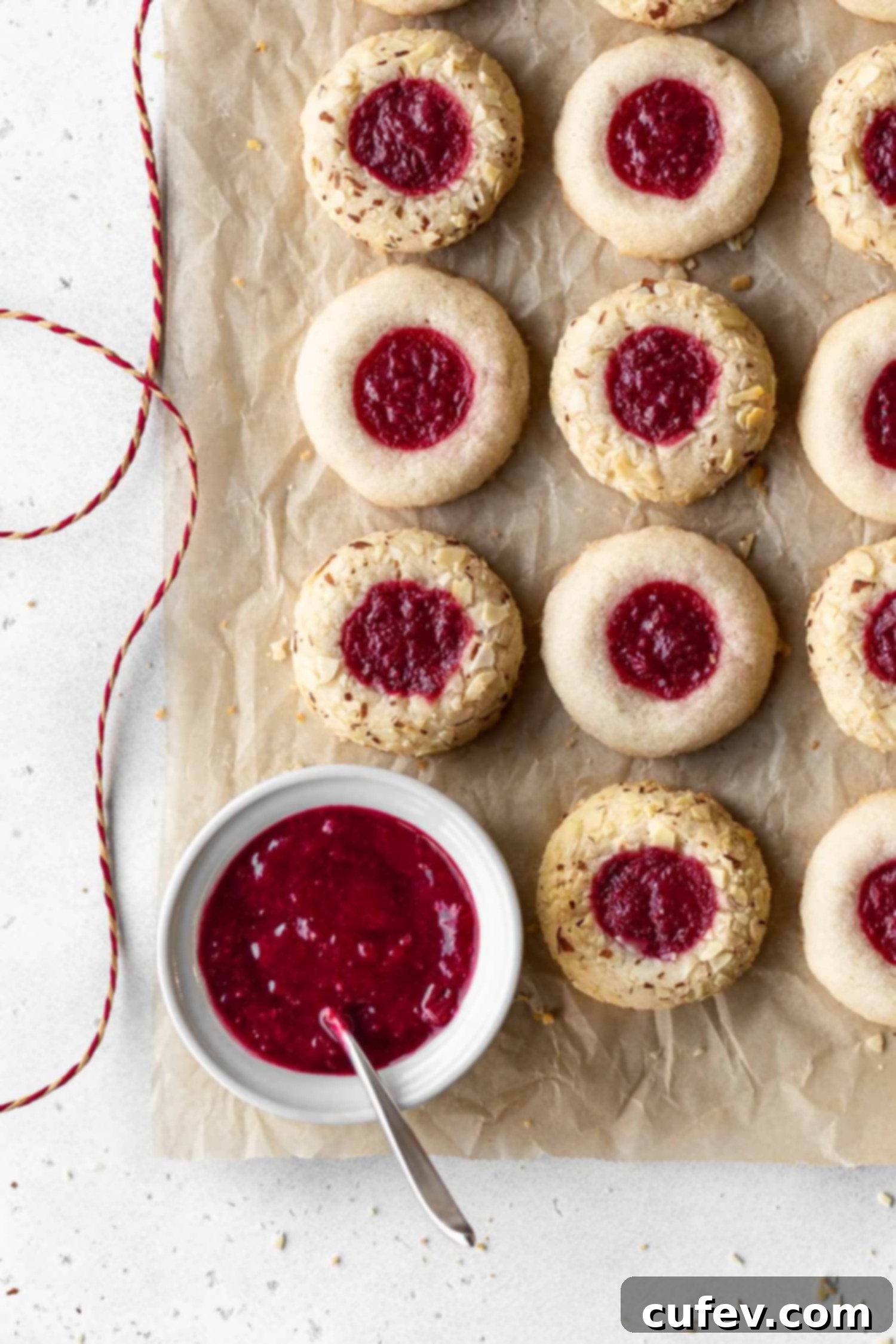 Gluten free and dairy free thumbprint cookies with a bowl of cranberry sauce