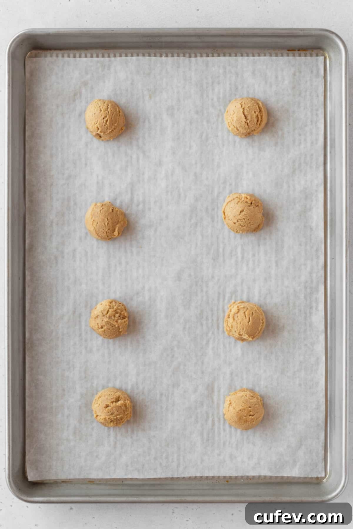 Perfectly Chewy Gluten-Free Ginger Cookies 11 Gluten free ginger cookie dough scooped on a baking sheet.