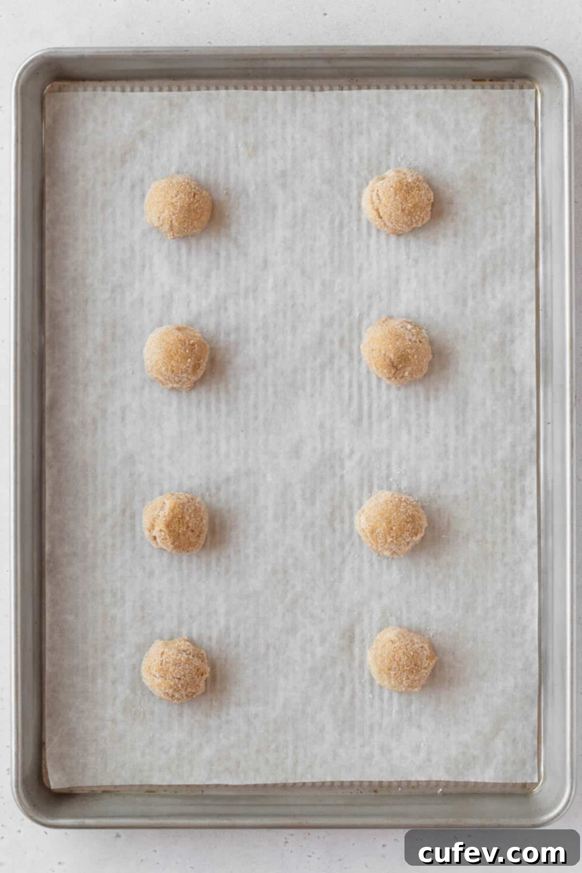 Perfectly Chewy Gluten-Free Ginger Cookies 12 Cookie dough rolled into sugar and placed on a baking sheet.