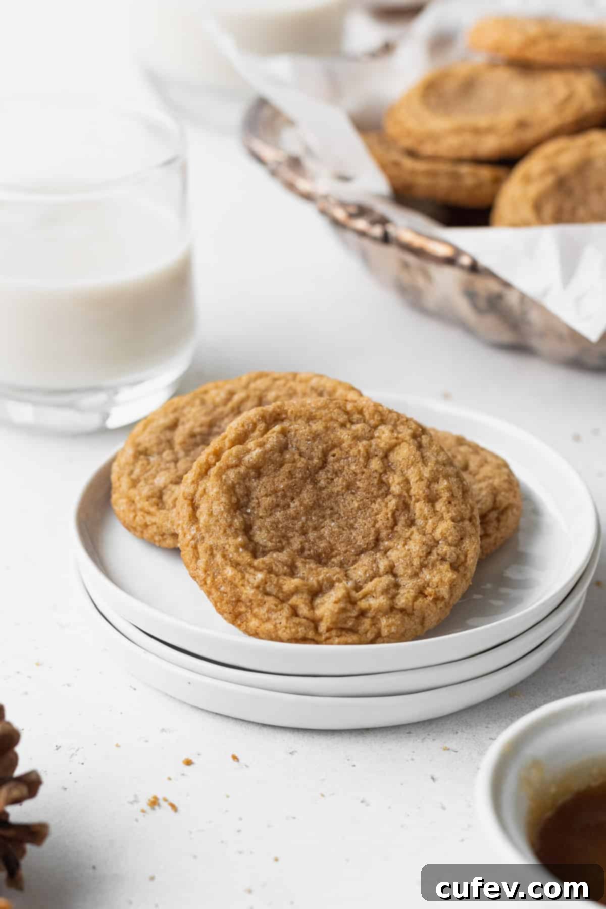 Perfectly Chewy Gluten-Free Ginger Cookies 15 Three gluten free ginger cookies on a stack of white plates.