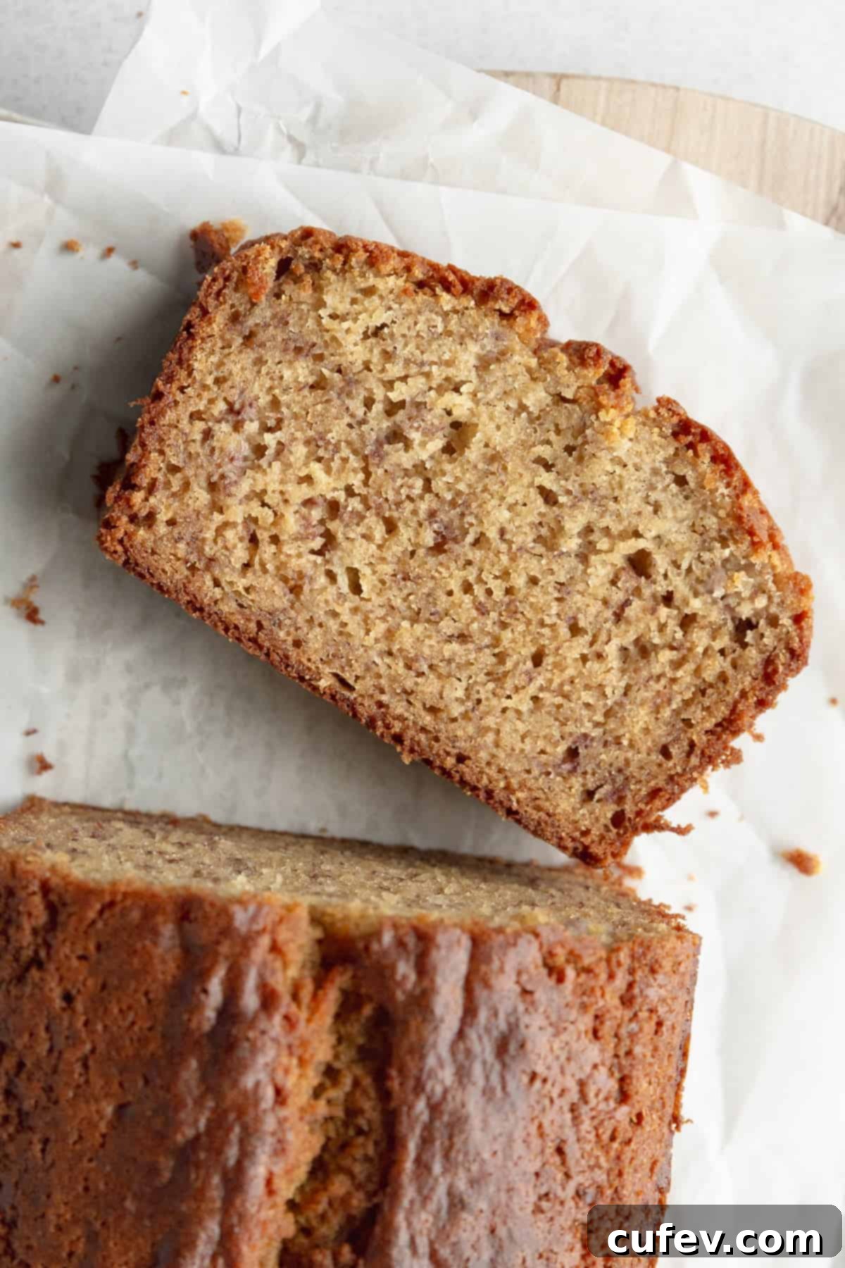 A slice of gf banana bread on parchment paper.