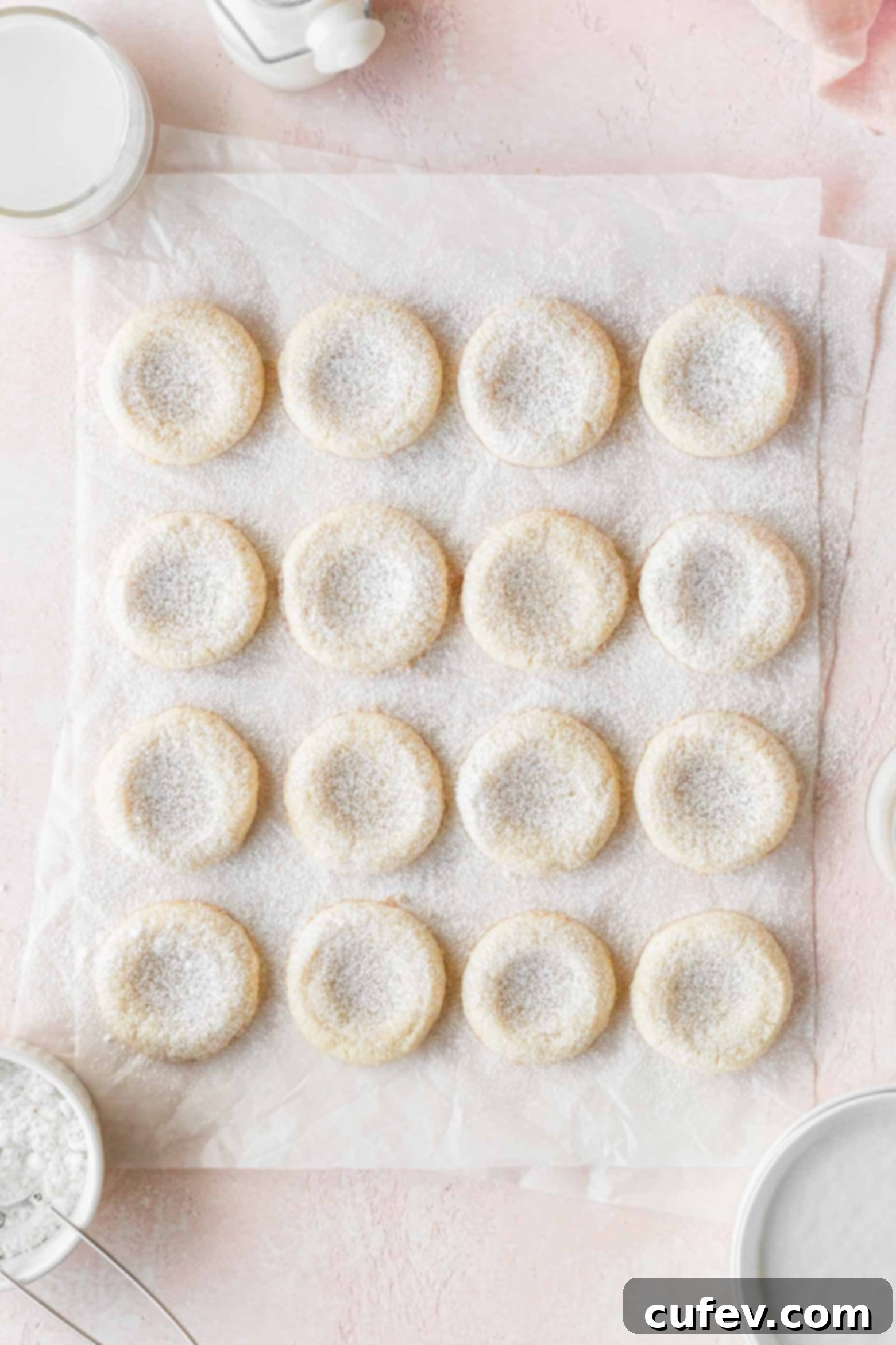 Freshly baked cookies elegantly dusted with a light layer of powdered sugar.