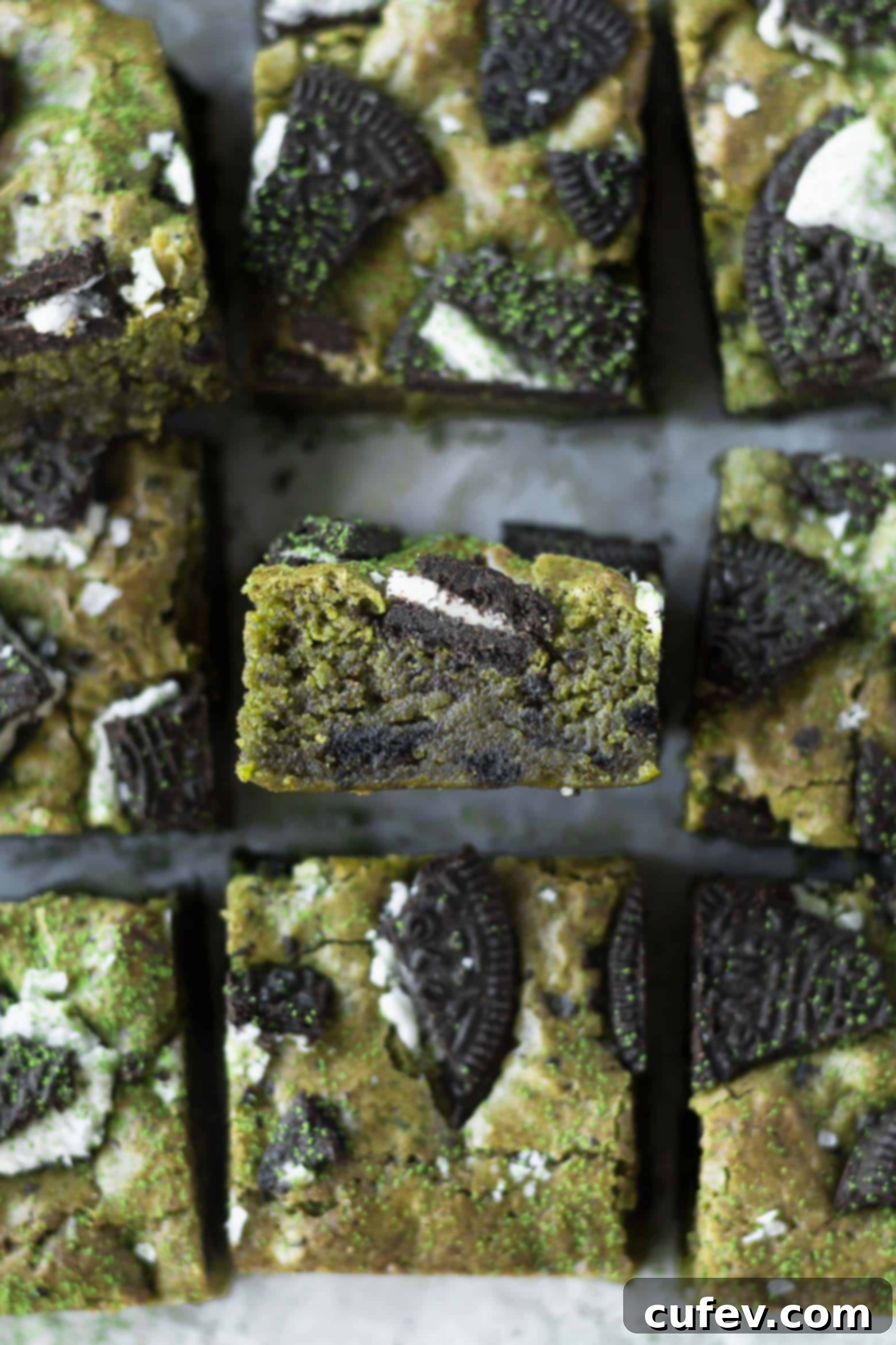 Stack of five fudgy matcha Oreo blondie squares, showing their thick, rich texture.