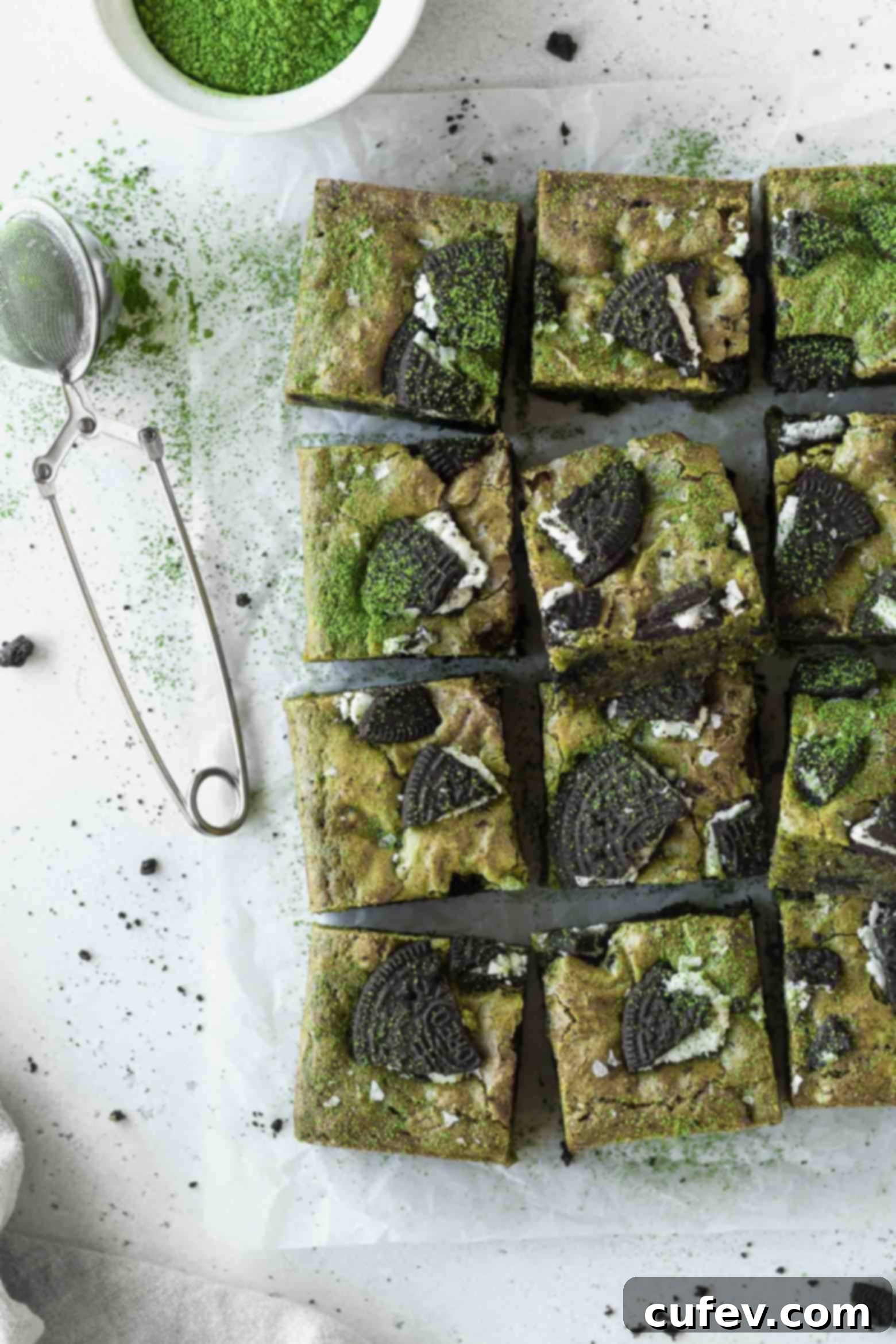 Neatly cut squares of matcha blondies arranged on parchment paper, ready to be served.
