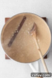 Creamy vegan rice pudding freshly cooked in a pot, ready to be transferred for cooling and chilling.