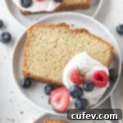 A slice of perfect gluten-free pound cake with whipped cream and berries in the recipe card.