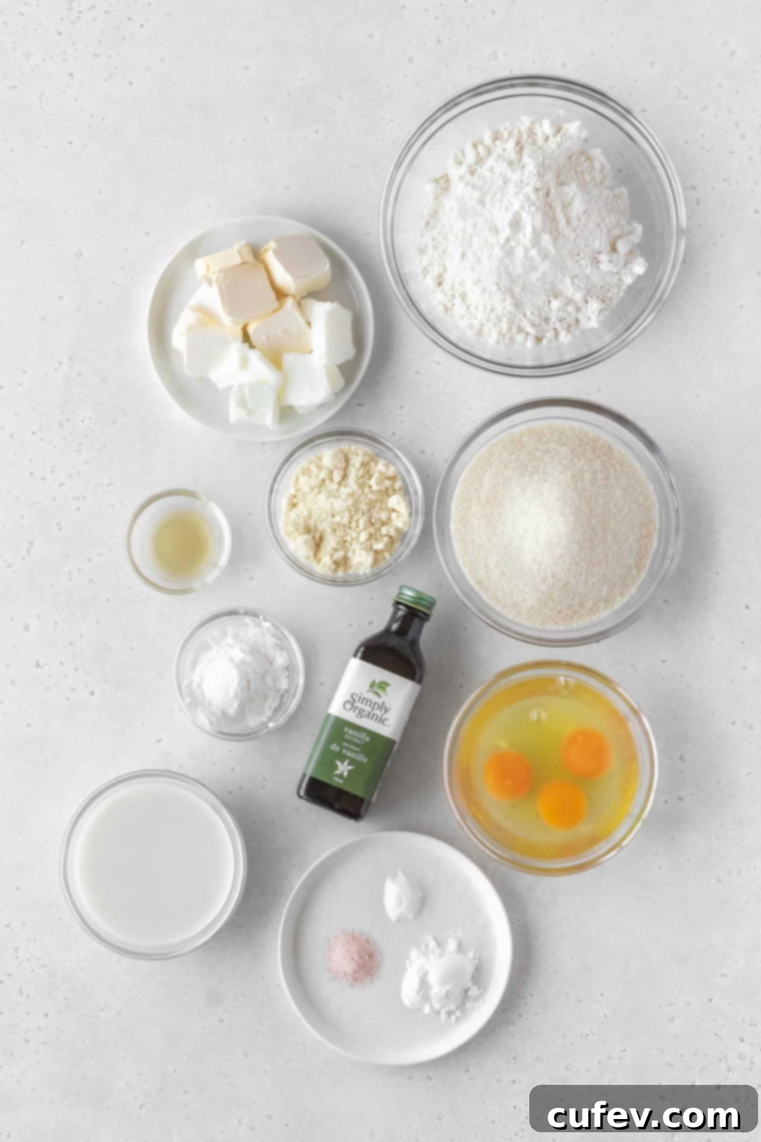 Various gluten-free pound cake ingredients neatly arranged in separate bowls on a kitchen counter.
