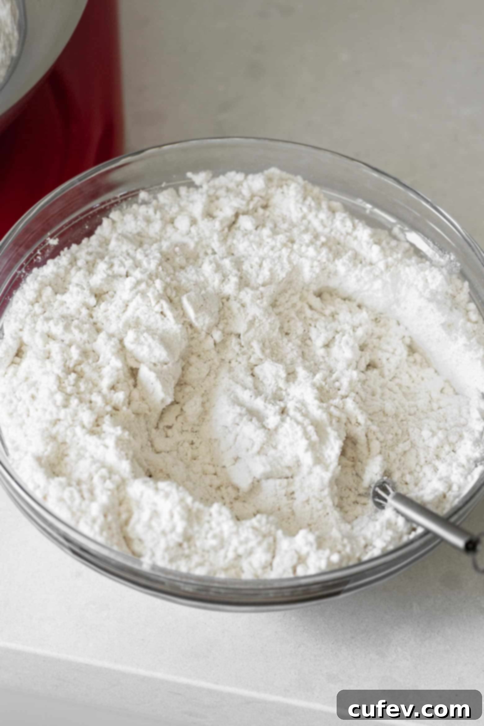 Flour, salt, baking soda, and baking powder mixed together in a bowl.