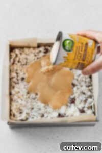 Pour a can of vegan sweetened condensed milk over the coconut.