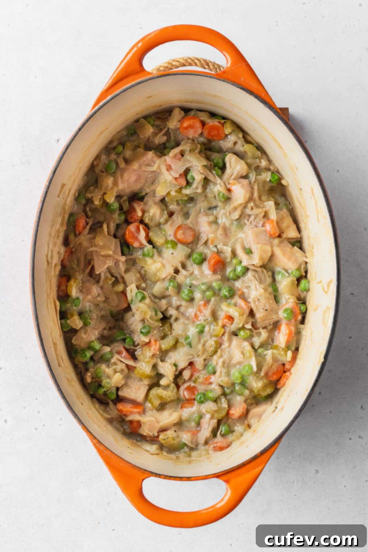 The rich, creamy, and vibrant vegan pot pie filling, beautifully prepared and simmering in an enamel pot, showcasing its perfect texture.